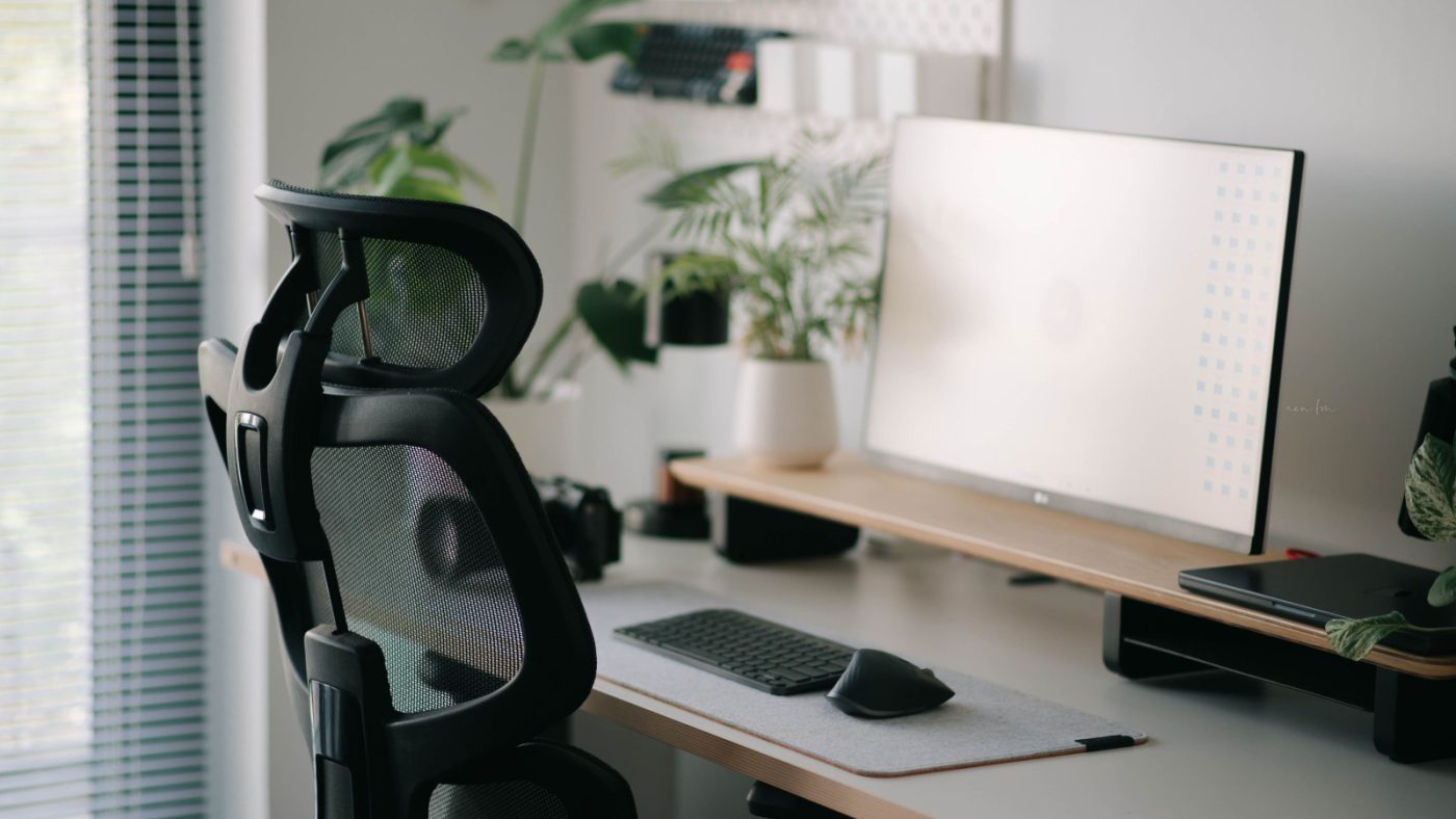 A modern home office with an ergonomic desk chair and monitor